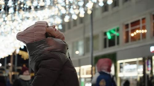 Woman Gazing at City Lights at Night
