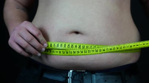 Overweight Man Measuring His Belly, Close Up. Unhealthy Diet and Obesity Concept