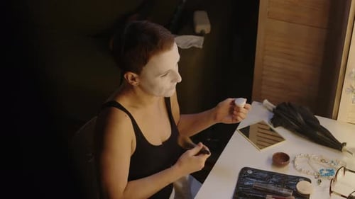 Mime Actress Doing Makeup in front of Backstage Mirror with Lamps