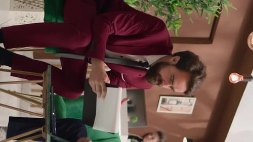 Man in Suit Working With Paperwork