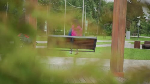 Cyclist Taking Brief Break Woman Cyclist Relaxes on Swing Amid City Park Greenery Cyclist Woman