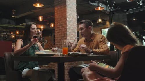 Family Having Dinner in Restaurant