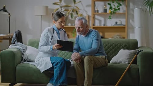 Doctor Consults with Senior Patient at Home