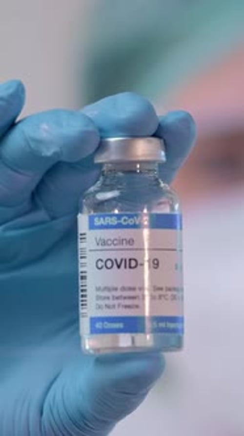 Closeup of Doctor Presenting a Covid19 Vaccine During a Vaccination Session