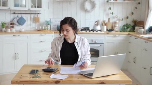 Stressresistant Woman Successfully Deals with Financial Documents Paying Utility Bills or Loans on