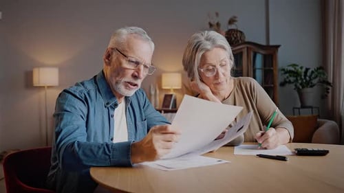 Senior Couple Reviewing Documents at Home
