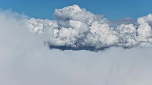 Aerial view of white puffy clouds and blue sky