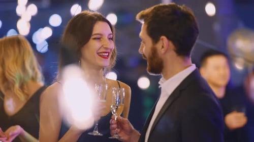 Elegant couple drinking champagne at formal corporate event