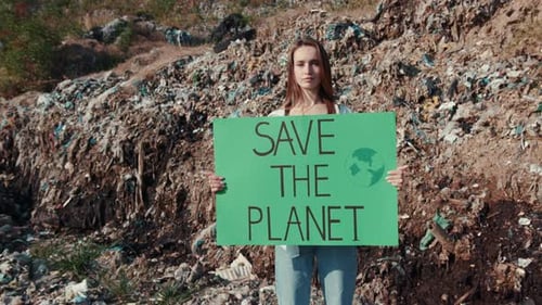 Young Woman Protests at Landfill to Save the Planet