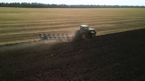 Tractors plowing the field in Ukraine