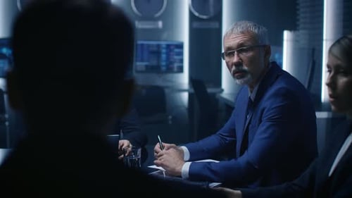 Team Discussing Data Charts During Meeting in Office