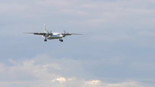 Propeller Plane Flies in Cloudy Daytime Sky