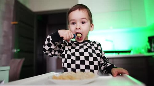 Cute Child Eating Meal in Modern Kitchen