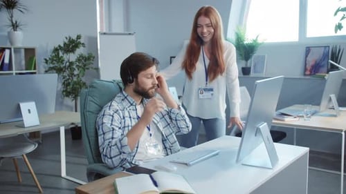 A Man and Woman Showcase Teamwork in a Collaborative Workspace