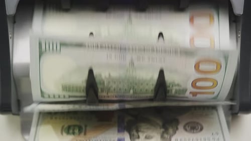 Machine Counting Stacks of United States Currency