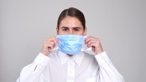 Beautiful Healthy Woman Wear Medical Face Mask on Over White Background