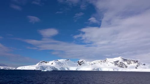 Snowy Mountains Meet the Blue Ocean