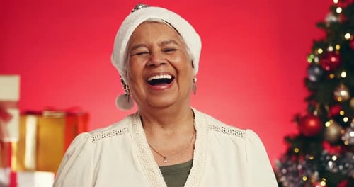 Laughing, Christmas and face of old woman in studio for holiday season, retirement and smile
