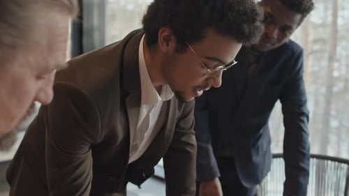 Business People Reviewing Charts at Workplace