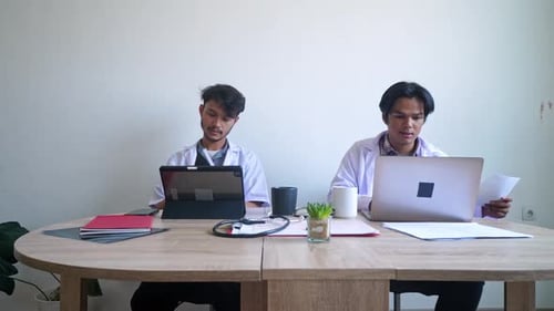Doctors Working at Desk in Office