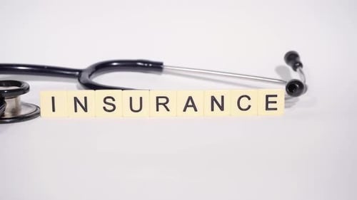 Stethoscope and Tiles Spelling the Word Insurance