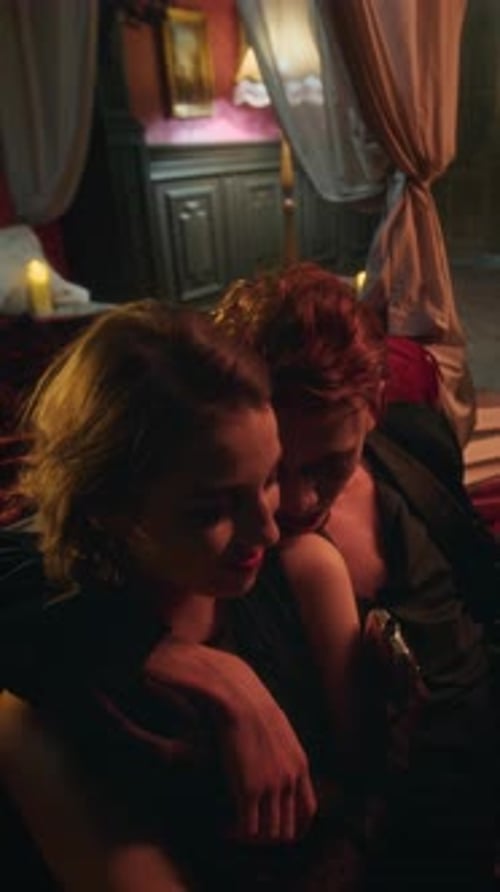Two Vampire Lovers Reclining Intimately Together on Floor