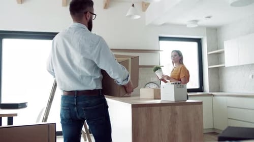 Couple Moving Boxes in New Home Kitchen