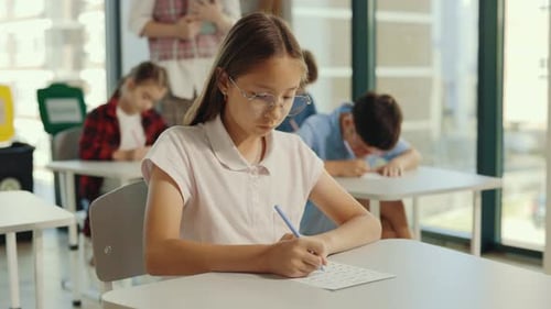 Focused Children Studying in School Classroom