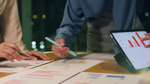 Asia businesspeople meeting plan analysis statistics brainstorm at office night.