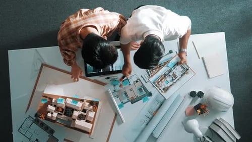 Top down view of business man and colleague design house together. Alimentation.