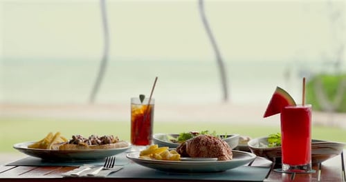 Coastal Dining Table with Delicious Meals and Fruity Drinks Beach