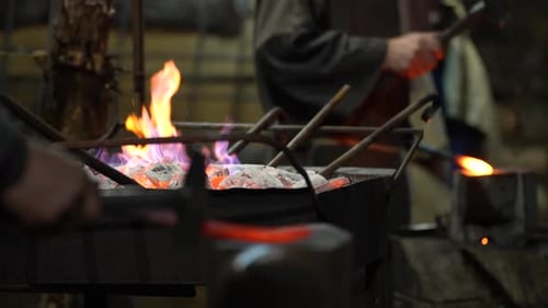 Blacksmith Works in Traditional Forge, Shaping Hot Metal into Tools and Weapons