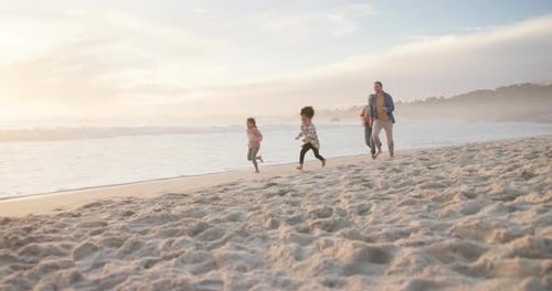Family, children and running on a beach together on holiday or vacation for bonding fun