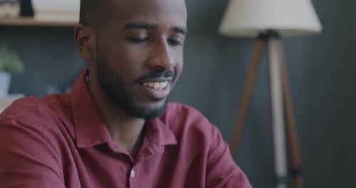 Closeup Tiltdown Portrait of African American Employe Working with Laptop Typing at Desk in Office