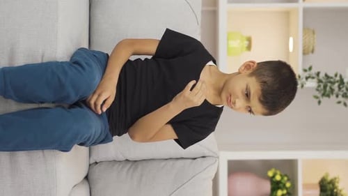 Boy with Skin Irritation Rubbing Chest and Neck