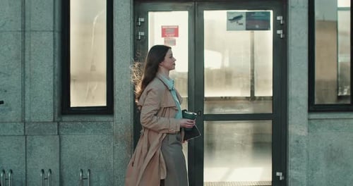 Side View Young Beautiful Boss Business Woman in Formal Beige Coat Walking with Laptop Along