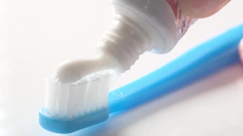 Applying Toothpaste to a Toothbrush Macro Video
