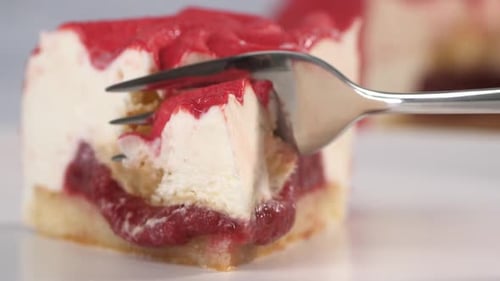 Fork Cuts Slice of Strawberry Cake