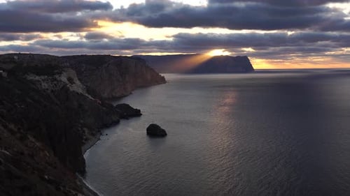 Sea Landscape with Rocky Coastline on Sunset Time with Cloudy Sky