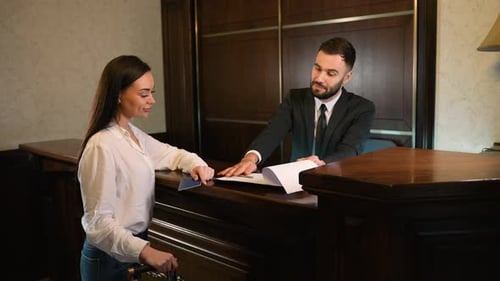 Woman Guest Checking in at Luxury Hotel Reception Desk
