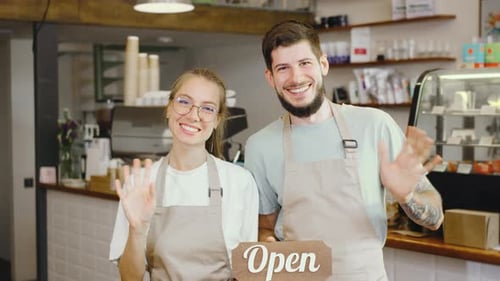 In a Cozy Cafe Two Cheerful Baristas Warmly Greet Customers Creating an Inviting Atmosphere The Open
