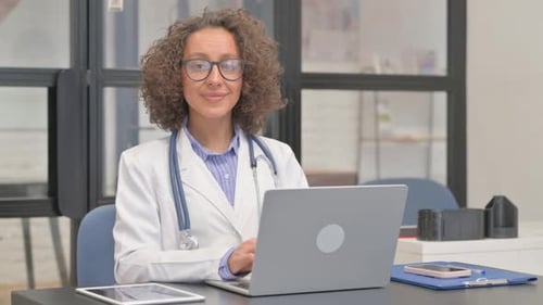 Hispanic Female Doctor Smiling at Camera in Hospital
