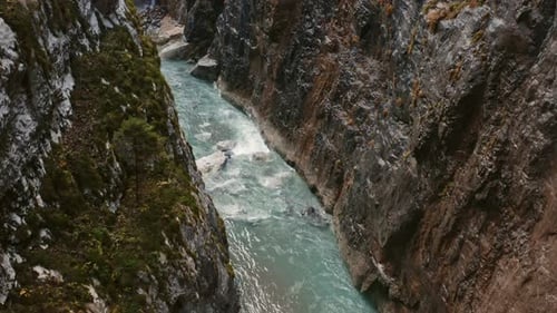 Flying Along Water Stream Inside Wet Rocky Ravine. Unveiling Waterfall. Autumn Colors.