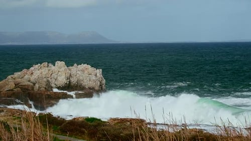 Turbulent waves crash into rocky Hermanus coastline