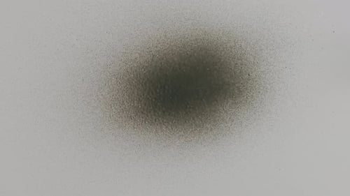 A Hand Spraying Paint From a Can