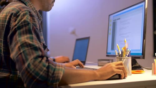 Deadline, Technology and People Concept - Programmer with Computer Working Together Late