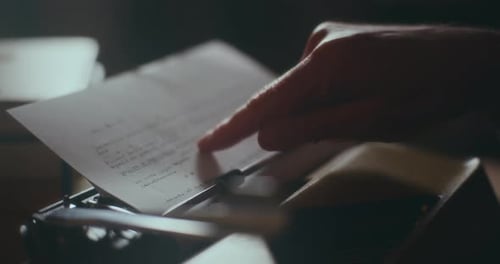 Hand Points at Text Typed on Typewriter