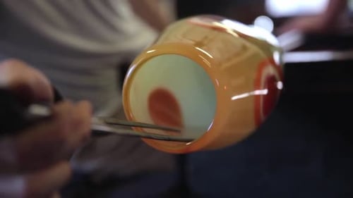 Glass blower masterfully shapes molten glass in calgary alberta workshop