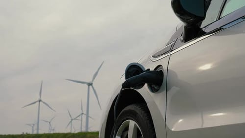 Electric Vehicles Near Wind Turbines Promoting Sustainable Energy