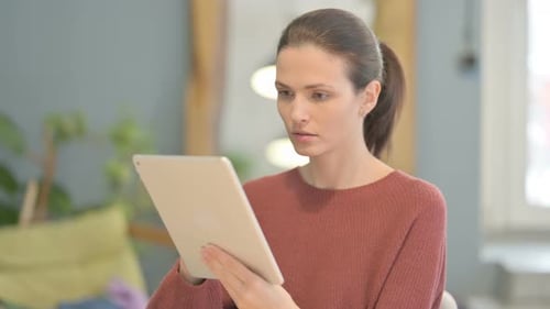 Young Adult Using Tablet Indoors During Daytime